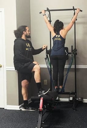 Coach Martin Rosa Kiefer of Hive Fitness Journey coaching a client through a strength lift in Woodstock, GA