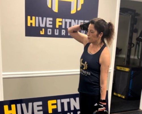 Hive Fitness Journey group training session in Woodstock, GA - coach leading adults through strength work